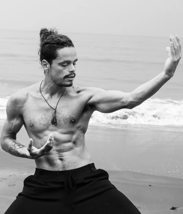 Aldo Salazar, creador escénico, ejecutando movimientos de danza contemporánea en la playa de Puerto Viejo.